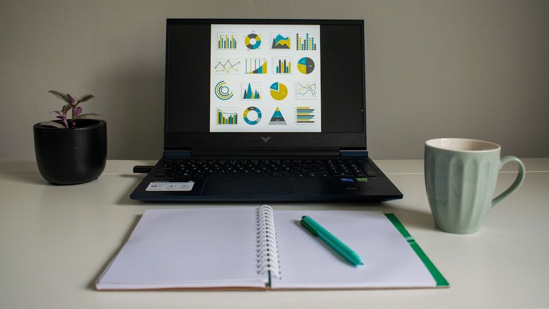 Overhead view of a research desk with laptop, notebook and coffee cup